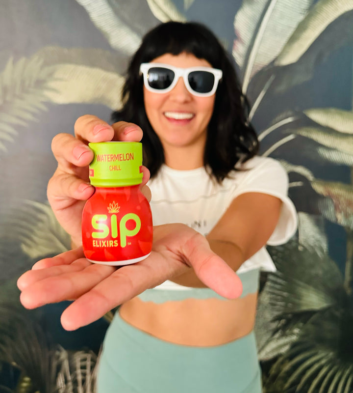 SIP Elixirs - Woman in white sunglasses holding Watermelon Chill SIP bottle