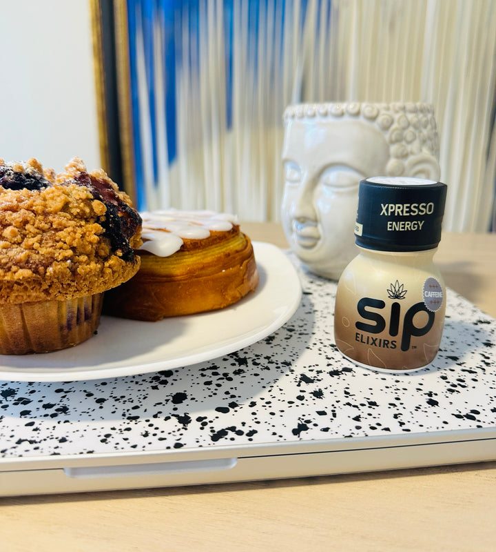 SIP Elixirs - Xpresso Energy bottle on desktop with pastries