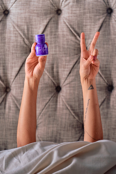 SIP Elixirs - Tattoo'd Woman in Bed with Dream Berry - Sleep bottle, Peace Sign